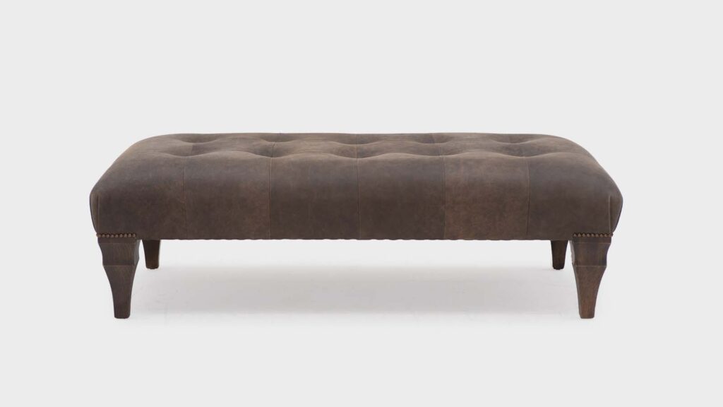 John Sankey small-rectangular-indented-ottoman covered in soft leather with antique stud detail to legs - Front
