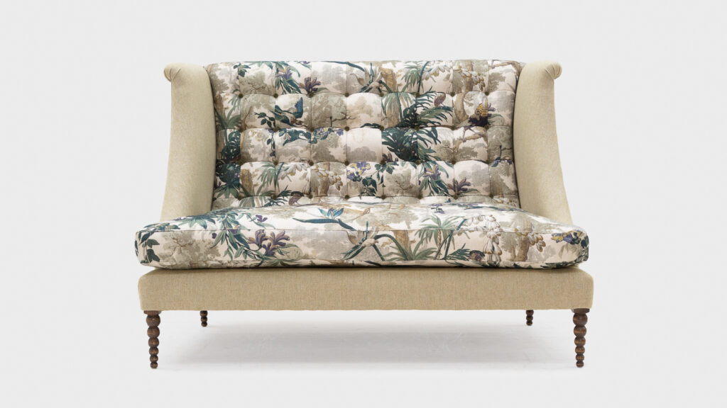 Green floral high back sofa with buttoned back and bobbin feet - front