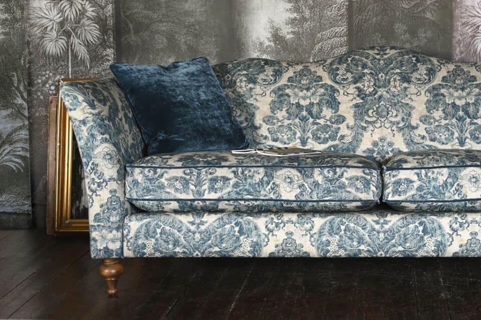John Sankey Wolsey Sofa with camel back covered in blue floral fabric