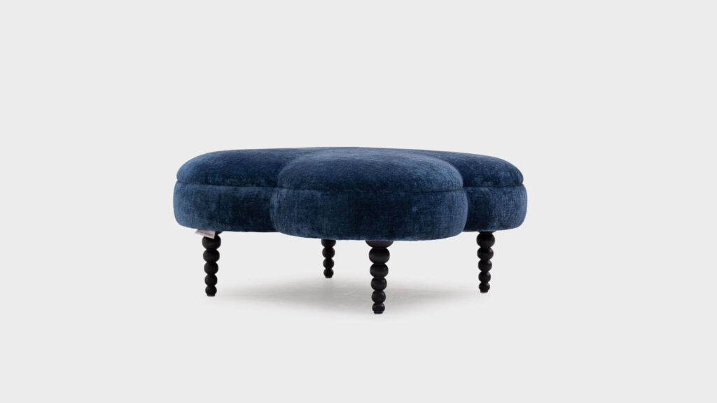 John Sankey Clover small ottoman covered in navy velvet with black bobbin legs - front