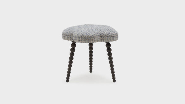 John Sankey floral footstool with dark bobbin legs covered in a slubby texture - front